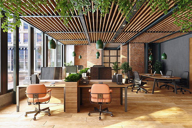 Sustainable open-plan modern office featuring desks, chairs, hanging lights, and plants