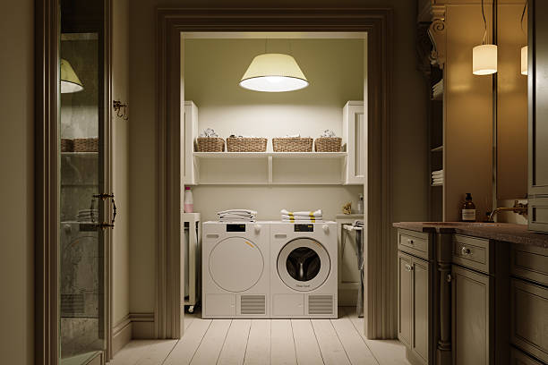 Cozy Laundry Room Interior with Modern Washer and Dryer, Warm Lighting and Elegant Cabinetry